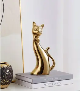 Objet décoratif à pose chat stylisé en céramique or 25x8x12 cm